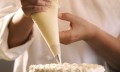 Close-up of a pastry chef decorating a cake
