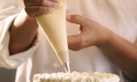 Close-up of a pastry chef decorating a cake
