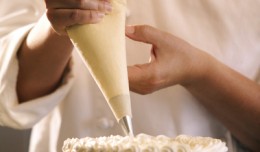 Close-up of a pastry chef decorating a cake