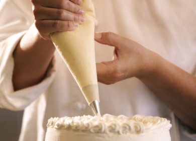 Close-up of a pastry chef decorating a cake