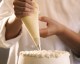 Close-up of a pastry chef decorating a cake