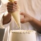 Close-up of a pastry chef decorating a cake
